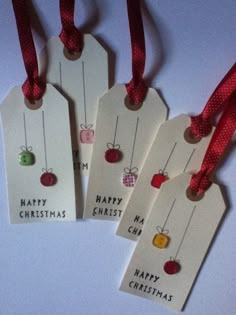 three tags with christmas ornaments hanging from them