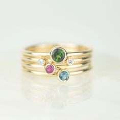 Introducing the Draco solid gold stacking ring set. The collection features vibrant jewel toned gems and sparkling diamonds set in solid recycled 9ct gold. Two tiny diamonds sit on one band, slightly apart, designed to sit beautifully on either side of the green tourmaline, ruby and london blue topaz rings. Our Andromeda stacking ring sets are named after constellations - Draco being the dragon. The rings are designed to be worn together and apart, creating a beautifully varied set. Material - M Ruby Tourmaline, Blue Topaz Rings, Topaz Rings, Gold Stacking Ring, Sterling Silver Stacking Rings, London Blue Topaz Ring, Stacking Ring Set, Purple Sapphire, Silver Stacking Rings