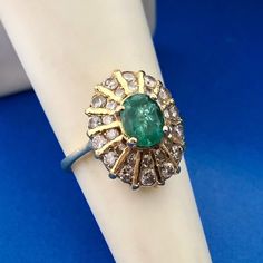 * Fabulous 18K Yellow Gold Oval Emerald Round Diamond Anniversary Cocktail Ring * Ring Size: 4.75 * Top of ring measures: 5/8" x 1/2" * Height: 3/8" * Oval Emerald total carat weight: approximately .85 tcw * Round Diamond total carat weight: approximately .70 tcw * Ring weight: 5.5 tgw * Marked: 18K * Condition: Great * G1720    Exported By ExportYourStore :) Oval Yellow Gold Diamond Ring Stamped 14k, Luxury Oval Hallmarked Emerald Ring, Luxury Stamped 14k Oval Cabochon Ring, Luxury Oval Cabochon 14k Stamped Rings, Luxury 14k Stamped Oval Cabochon Ring, Luxury Oval Yellow Gold Emerald Ring, Luxury Oval Emerald Ring In Yellow Gold, Luxury Oval Emerald Ring With Prong Setting, Heirloom Oval Halo Ring Hallmarked