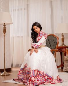 This Habesha dress is a true work of art, made of high-quality Menen fabric that is known for its elegance and beauty. The dress features stunning Mulu Tilf embroidery on the bodice and sleeves, adding a touch of sophistication and class. The tilf embroidery is done in a way that highlights the beauty of the Menen fabric, creating a stunning contrast that is both timeless and modern. The dress is designed with a flattering fit that accentuates the curves, and the flowing skirt adds a graceful to Traditional Dress With Fitted Bodice For Festive Occasions, Floor-length Dresses With Traditional Patterns For Ceremonies, Traditional White Dress With Fitted Bodice, Traditional Festive Dress With Fitted Bodice, Festive Traditional Dress With Fitted Bodice, White Formal Dress With Traditional Drape, Elegant White Maxi Dress For Traditional Ceremonies, Traditional White Formal Gown, Traditional Floor-length Dress With Fitted Bodice