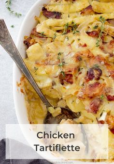 a casserole dish with meat and vegetables in it on a white plate next to a spoon