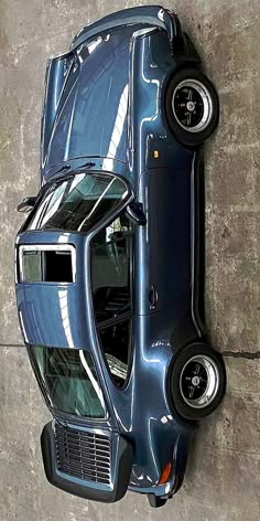 an overhead view of a blue car with its hood up