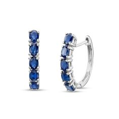 Add a fun pop of color to your attire with these gemstone huggie hoop earrings. Fashioned in sterling silver, each hoop showcases a row of 4.0 x 3.0mm oval-shaped bright blue sapphires. Buffed to a brilliant luster, these earrings secure with lever backs. Oval Sterling Silver Huggie Earrings For Gift, Oval Sterling Silver Huggie Earrings As Gift, Sterling Silver Oval Hoop Earrings Fine Jewelry, Blue Sterling Silver Huggie Earrings, Sterling Silver Gemstone Huggie Earrings, Classic Sterling Silver Hoop Earrings With Gemstone, Classic Sterling Silver Gemstone Hoop Earrings, Oval Huggie Earrings Fine Jewelry, Sapphire Sterling Silver Hoop Earrings