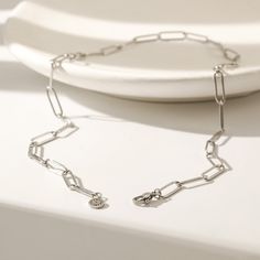 Introducing our signature necklace, featuring a 17.5" paperclip chain with the Karola & Co. flower emblem and clasp. The ultimate accessory for the modern, sophisticated woman. Elegant Silver Paperclip Bracelet, Formal Metal Necklace With Paperclip Chain, Formal Paperclip Bracelet, Elegant Silver Chain Link Paperclip Bracelet, Elegant Silver Link Paperclip Bracelet, Elegant Sterling Silver Paperclip Bracelet With Cable Chain, Formal Silver Paperclip Bracelet With Cable Chain, Formal Silver Paperclip Chain Bracelet, Classic Metal Necklace With Paperclip Chain