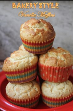 several muffins stacked on top of each other in a red bowl with the words bakery style vanilla muffins