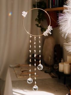 a wind chime hanging from the ceiling next to a white christmas tree ornament