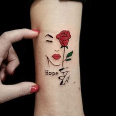 a woman's arm with a rose and the words hope tattooed on her wrist