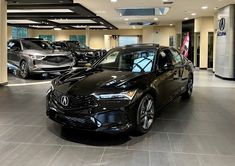 a black car is parked in a showroom