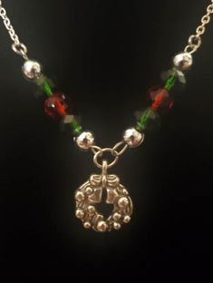 Handmade one of a kind jewelry. Silver Christmas Reef Necklace accented by red and green beads, accompanied by a silver chain. Whether you want to wear this for Christmas or give it as a gift you can't go wrong. Handmade Round Jewelry For Christmas, Handmade Round Christmas Jewelry, Beaded Jewelry Christmas Gift, Beaded Jewelry For Christmas Gift, Christmas Beaded Jewelry Gift, Handmade Jewelry For Christmas Celebration, Christmas Holiday Green Jewelry, Green Christmas Holiday Jewelry, Holiday Red Nickel-free Jewelry