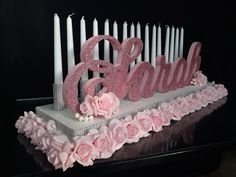 there is a cake with candles and flowers on it