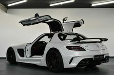 the mercedes sls amg roadster is shown with its doors open