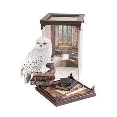 an owl is sitting on top of some books