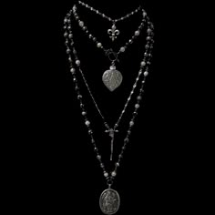 The Lujan Choker features an intricately carved Our Lady of Lujan medal within a flaming Sacred Heart made of Sterling Silver. She's surrounded by Angels, with two of them raising a crown of flowers above her. Pilgrims worldwide travel to see Her and have received special graces, favors and miracles. The gunmetal linked chain is offered in 17" or 22" based on your preference. If you need a longer or shorter size we can make one for you. It's a very special necklace because of the rarity of the m Luxury Spiritual Silver Beaded Necklaces, Gothic Jewelry Dixi, Cheap Vintage Black Necklace, Victorian Spiritualist Jewelry, Luxury Gothic Collectible Necklaces, Gothic Jewelry Pearls, Black Jewelry Necklace Stone, Cheap Black Spiritual Necklaces, Cross Pendant Necklace Gothic