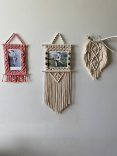 three pictures hanging on the wall with tassels