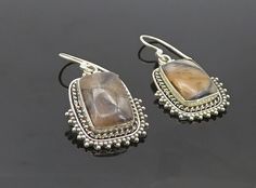 "925 Sterling Silver - Vintage Agate Shiny Twist Border Dangle Earrings - EG3782  925 Sterling Silver - Vintage Agate Shiny Twist Border Dangle Earrings - EG3782  Jewelry Type:         Earrings   Metal Type:            925 Silver   Metal Size:             1.5\"  Stone Type:            Agate   Condition:              N/A  Jewelry Weight:     7.3 Grams  PLEASE NOTE: THIS ITEM IS PRE-OWNED. ALTHOUGH MOST ITEMS ARE IN VERY GOOD CONDITION, SOME MAY NEED CLEANING AND/OR MINOR REPAIRS. WE MAKE A VERY STRONG EFFORT TO UPLOAD CLEAR PICTURES. PLEASE INSPECT ALL PICTURES AND ASK ALL QUESTIONS YOU MAY HAVE PRIOR TO MAKING A PURCHASE. NOT ALL STONES ARE GENUINE, SOME ARE ENHANCED OR CREATED." Elegant Silver Agate Earrings, Brown Sterling Silver Earrings With Natural Stones, Silver Agate Drop Earrings, Silver Agate Gemstone Earrings, Pierced Silver Agate Jewelry, Nickel-free Silver Agate Earrings, Silver Agate Jewelry, Earrings Metal, Types Of Metal