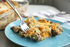 a blue plate topped with food next to a casserole dish