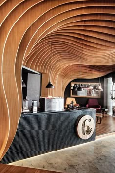 the interior of a coffee shop with wood slats on the walls and wooden flooring