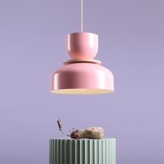 a pink lamp hanging from a purple ceiling