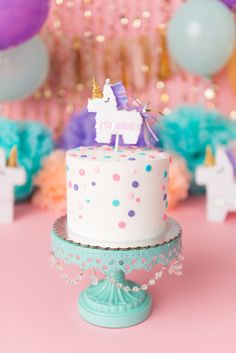 a birthday cake with a unicorn topper on it