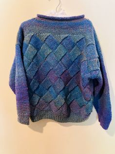 Really special, one-of-a-kind handknit sweater with gorgeous color palette of blues, purples, and greens. Super-soft and cozy. Your kiddo will want to wear this all winter long. Lattice knit features on front and back. So cute!  The details:  Size: Unmarked, but fits like Kids M/L (see measurements below) Material: 100% acrylic Measures: 18" pit to pit, 17" length Condition: Excellent vintage condition Pretty Sweaters, Handmade Sweater, Hand Knitted Sweaters, Purple Sweater, Green Sweater, Blue Sweaters, Crochet Clothes, Green And Purple, Colorful Sweaters