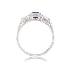 This cushion cut diamond and sapphire ring features a breathtaking 0.95 carat sapphire set in between two additional diamonds, weighing a total of 0.60 carats. Set in platinum, three more diamonds adorn the shoulders. ✦ DIAMOND SPECIFICATIONS: Diamond Cut: Cushion Cut Diamond Weight Diamonds: 0.60 Carat, sapphire: 0.95 carat ✦ ENGAGEMENT RING SPECIFICATIONS: Ring Material: Platinum Stones: Diamond, Sapphire ✦ WHAT COMES IN YOUR SHIPMENT: - Your Engagement Ring - Quality Ring Box - Jewelry Cleane Formal Platinum Rings With Trillion Cut, Three Stone Diamond Gemstones For Anniversary, Formal Three-stone Emerald-cut Birthstone Ring, Classic Trillion Cut Sapphire Ring, Formal Three Stone Emerald Cut Birthstone Ring, Formal Emerald Cut Three Stone Birthstone Ring, Emerald Cut Three Stone Birthstone Ring For Formal Occasions, Trillion Cut Sapphire Gemstone Ring For Anniversary, Fine Jewelry Three Stone Opal Ring