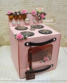 a pink toy stove with flowers on it