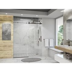 a large bathroom with a walk in shower next to a white sink and wooden counter top