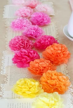 several different colored flowers sitting on top of a table