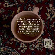 a cup of coffee sitting on top of a rug with a quote written in it