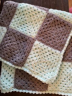 two crocheted squares on top of each other in brown, white and green