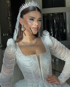 a woman wearing a wedding gown and tiara