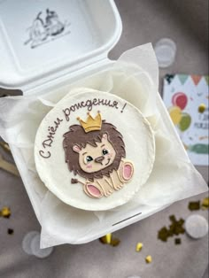 a badge with a lion on it sitting in a box next to confetti