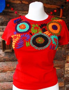 "Mexican embroidered shirt Beautiful embroidered blouse. This is handmade in Mexico. Perfect for those summer days at the beach, or for your fiesta parties. The embroidery colors may vary due all the handmade work (not the design). If you want an specific color, please send us a message so we can send you the ones available so you can choose. Size: Extra Small: 13\" width x 22\" long Small; 14\" width x 23\" long Medium: 15 1/2\" width x 24\" long (Width: shoulder - shoulder) Please also notice Bohemian Red Cotton T-shirt, Embroidered Short Sleeve Beach Shirt, Embroidered Short Sleeve Shirt For Beach, Multicolor Floral Embroidery T-shirt For Summer, Beach Cotton Embroidered Shirt, Embroidered Summer Shirt For The Beach, Cotton Beach Shirt With Floral Embroidery, Beach Cotton Shirt With Floral Embroidery, Multicolor Floral Embroidered T-shirt For Summer