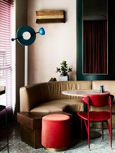 a living room filled with furniture and a round table