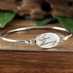 Actual Handwriting Bangle Bracelet, Memorial Bracelet, Sympathy Gift, Personalized Engraved Bracelet, Gift for Her, Signature Bracelet This laser engraved Stainless Steel bangle bracelet is a perfect gift for your Mom, Best Friend or Bride or Bridesmaids! or anyone you choose! Personalized with actual handwriting. This is engraved into high quality heavy gauge stainless steel. Engravable Portion: 15mm x 24mm Stainless Steel does NOT tarnish. How to order: 1. Add this item to your shopping cart 2 Engraved Adjustable Spiritual Charm Bracelet, Adjustable Engraved Spiritual Charm Bracelet, Engraved Friendship Bracelet Jewelry, Personalized Spiritual Bangle Bracelet, Spiritual Engraved Bracelets For Anniversary, Engraved Adjustable Bangle Name Bracelet, Engraved Charm Bracelet For Friendship, Symbolic Engraved Bracelets For Anniversary, Silver Bracelet With Engraving Option For Friendship