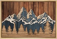 a wooden cutout of mountains and trees