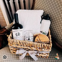 a wicker basket filled with wine and cheese