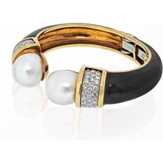 Indulge in the allure of elegance with the David Webb Platinum & 18K Yellow Gold Black Enamel and Pearl Diamond Bracelet. This exquisite piece captures the essence of timeless sophistication and artistry. Crafted with meticulous attention to detail, it showcases a harmonious blend of 18k yellow gold and platinum, creating a luxurious contrast that is sure to catch the eye.Drawing inspiration from the glamour of the 1970s, this hinged cuff bracelet boasts button cultured pearls and sparkling diam Luxury Round Bangle For Formal Occasions, Luxury Round Bangle For Evening, Formal Pearl Bracelet, Elegant Bracelet Strap Jewelry For Formal Occasions, Luxury Bangle Bracelets For Evening, Elegant White Gold Bangle For Evening, Luxury Polished Finish Bangle For Formal Occasions, Luxury Yellow Gold Bangle For Evening, Elegant Polished Bangle