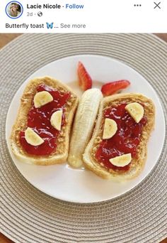 two pieces of bread with peanut butter and jelly on them sitting on a white plate