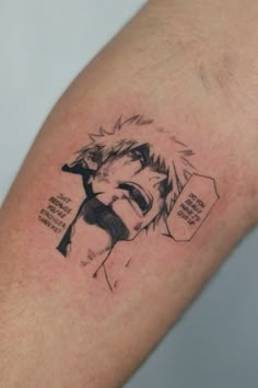 a man's arm with an anime tattoo on it