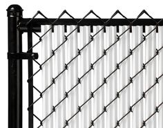 a close up view of a chain link fence with white and black paint on it