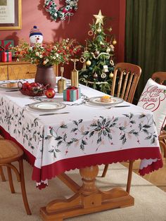 a dining room table set for christmas dinner