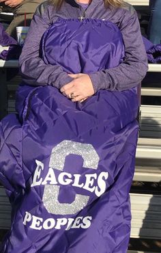 a woman in a purple jacket with the number 8 on it