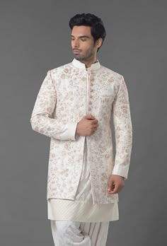 Ivory Color Embroidered Sherwani Cream Sherwani With Chikankari Embroidery And Long Sleeves, Cream Long Sleeve Sherwani With Chikankari Embroidery, Transitional Bandhgala In Raw Silk With Chikankari Embroidery, Off White Naqshi Sherwani For Diwali, Off White Bandhgala With Naqshi For Diwali, Off White Naqshi Bandhgala For Diwali, Off White Dabka Kurta For Reception, Designer Raw Silk Bandhgala With Chikankari Embroidery, Off White Bandhgala With Dabka For Eid