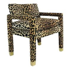 a leopard print chair with gold legs