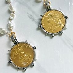 If you're looking for a Spectacular Statement Necklace, look no further….🌟 Large reproduction French coin in matte gold set in decorative silver bezel. We've done a few variations of this design, it's been one of our best sellers. This beauty hangs from a gold beaded vintage style glass pearl chain with lobster clasp which can be adjusted to wear up to 20” in length. Need it longer? Just choose your length from our drop down menu! Chain and clasp are brass based with gold electroplate and a pro French Face, French Coins, Lady Liberty, Custom Jewelry Design, Pearl Chain, Champagne Gold, Gold Set, Matte Gold, Gold Beads