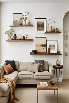 a living room filled with furniture and pictures on the wall above it's shelves