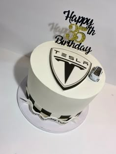 a birthday cake with the tesla logo on it