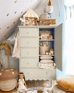 a child's room with toys and decor on the floor, including a dresser