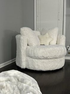 a white chair sitting on top of a hard wood floor